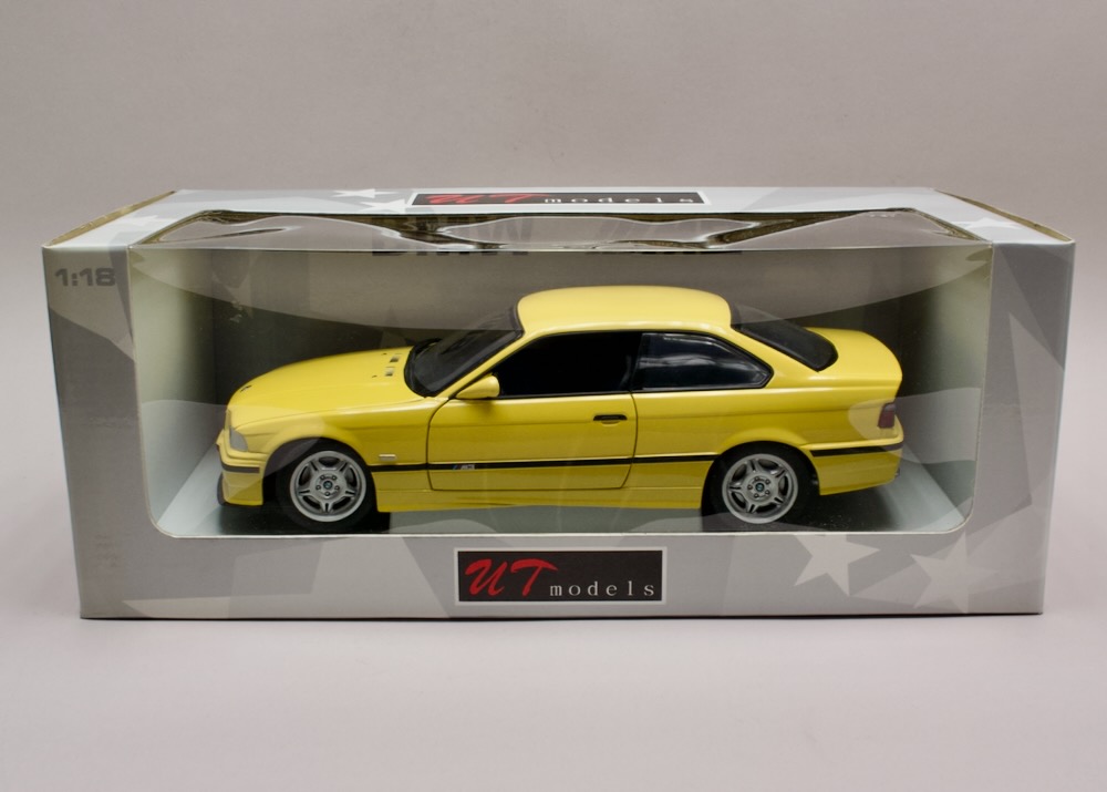 BMW M3 Coupe (E36) 1996 1:18 UT Models 180022300 – žlutá, původní balení, bez zajištění páskou